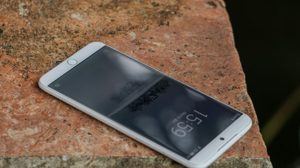 A cell phone sitting on top of a rock
