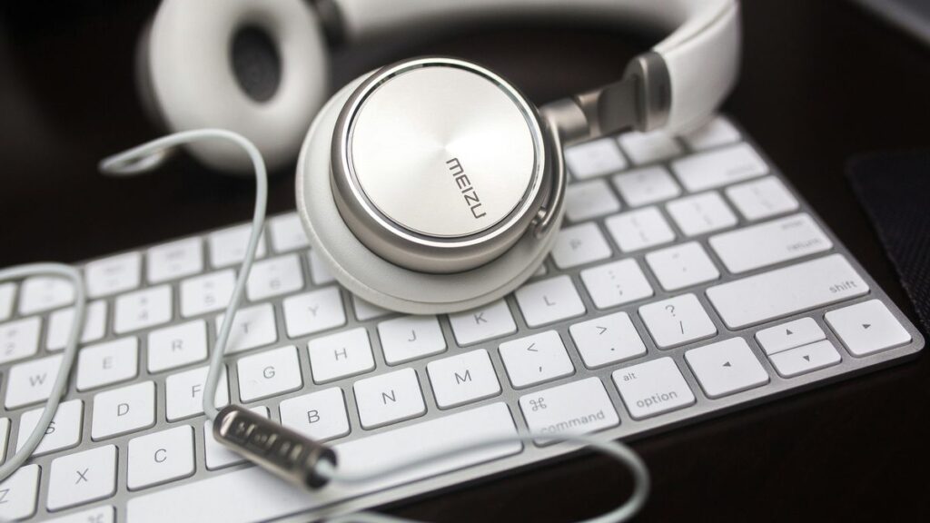 white Menzu corded headphones on Apple Magic keyboard