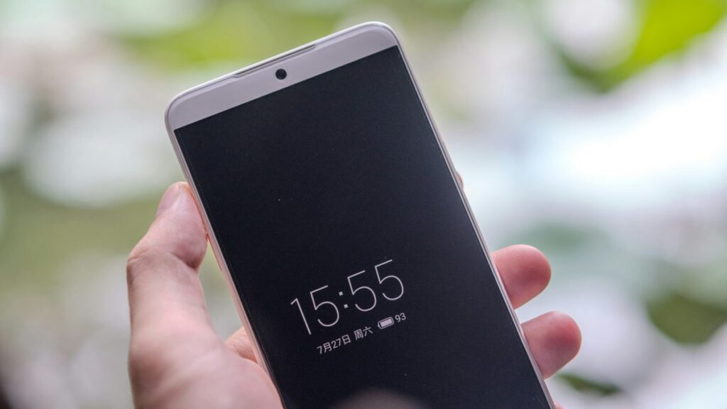 A person holding a cell phone in their hand