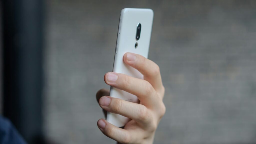 A close up of a person holding a cell phone